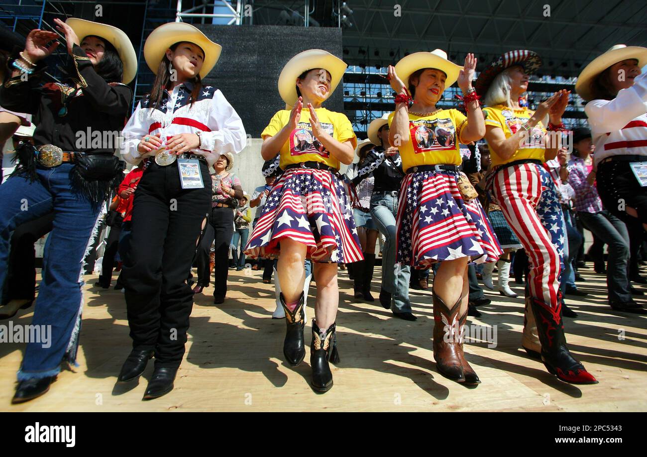 Japanese country music enthusiasts perform a line dance during the 18th  Country Gold, country music festival in Kumamoto, southwestern Japan,  Sunday, Oct. 15, 2006. The music is a big draw, but many