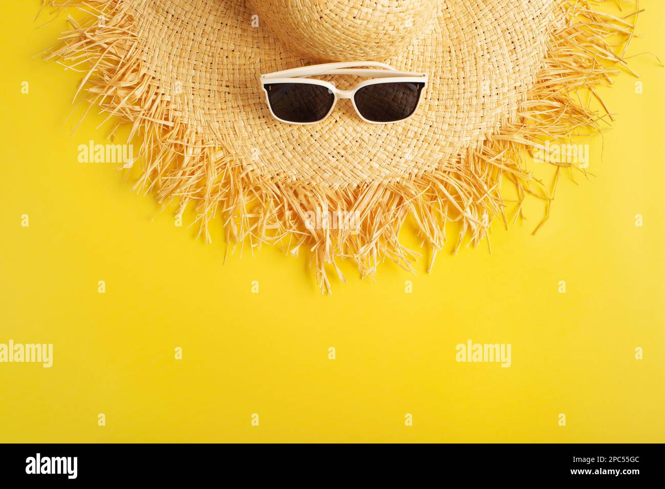 Sunglasses and straw hat on yellow background vacation travel planning ...