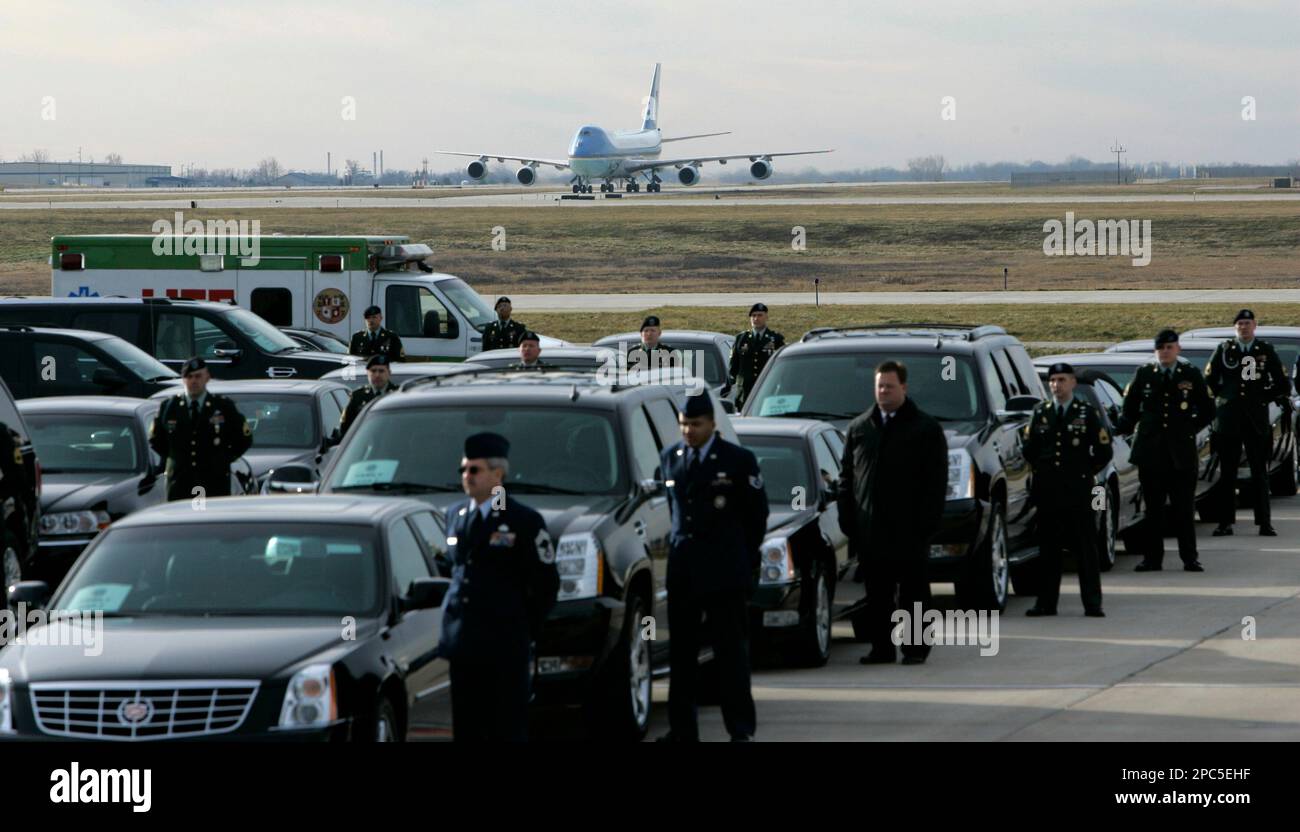 Limousines and drivers stand by as the aircraft carrying the remains of ...