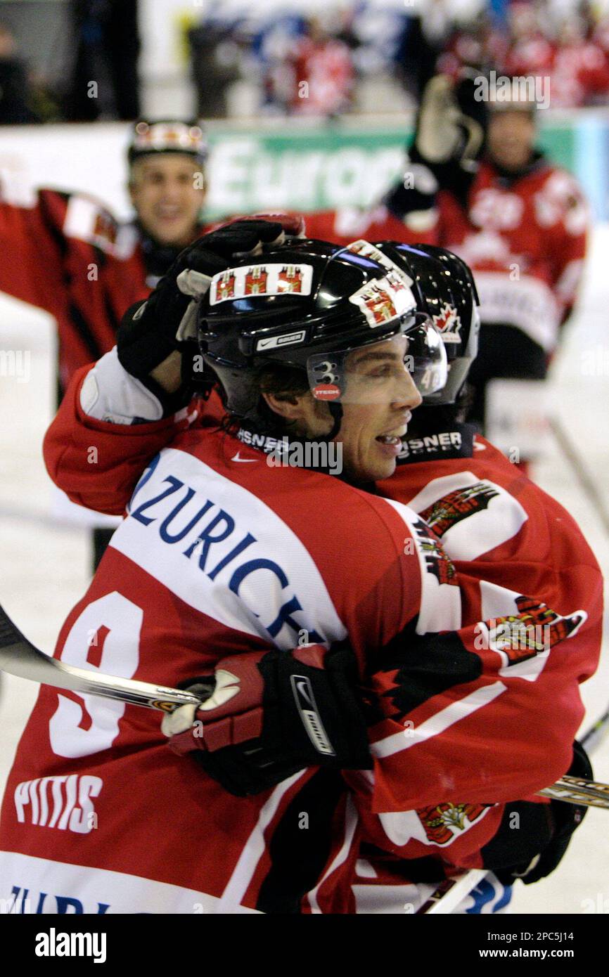 Team Canada player Dominic Pittis, left, and Mario Scalzo, right, celebrate their sides first goal during the final game between HC Davos and Team Canada at the 80th Spengler Cup ice hockey