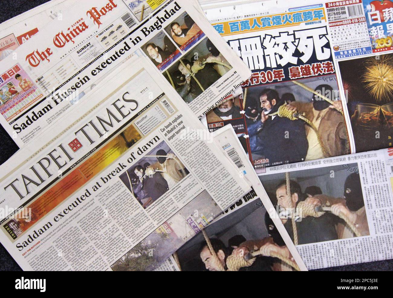 Taiwanese newspapers front pages carry stories and pictures of the execution of deposed Iraqi President Saddam Hussein, Sunday, Dec. 31, 2006, in Taipei, Taiwan. Saddam Hussein went to the gallows before sunrise Saturday, executed by vengeful countrymen after a quarter-century of remorseless brutality that killed countless thousands and led Iraq into disastrous wars against the United States and Iran. (AP Photo) Stock Photo
