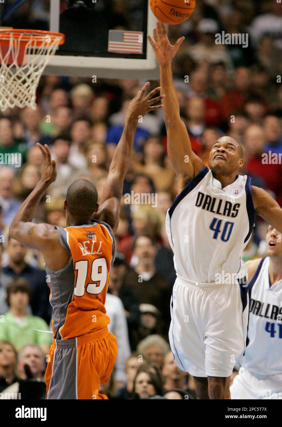 Dallas Mavericks forward Devean George (40) knocks the ball away from  Phoenix Suns guard Raja Bell (19) as he shoots the ball in the second half  of an NBA basketball game in