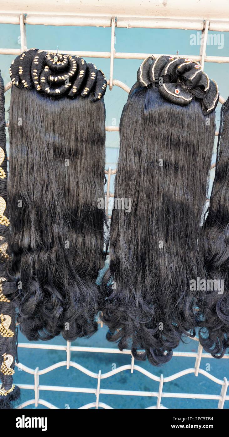 Bangalore,Karnataka,India-January 01 2023: Womens black hair wig is on sale in the streets of Shivaji nagar, Opposite to Busstand, Bangalore. Stock Photo