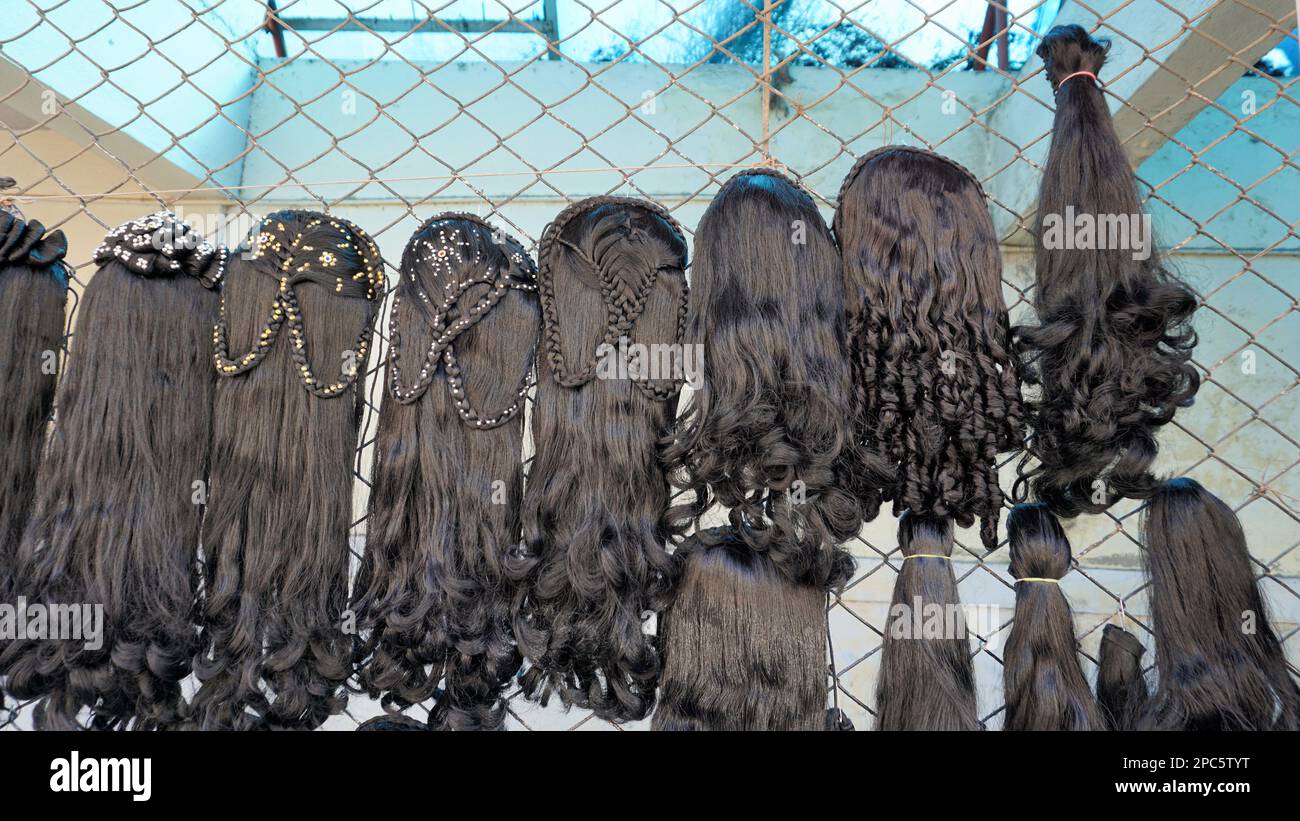 Bangalore,Karnataka,India-January 01 2023: Womens black hair wig is on sale in the streets of Shivaji nagar, Opposite to Busstand, Bangalore. Stock Photo