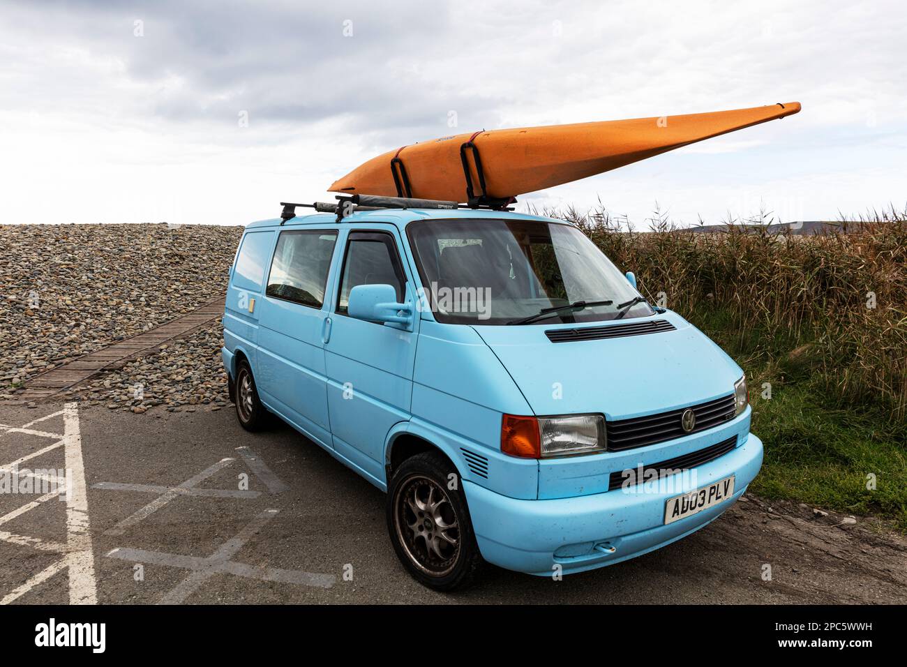 VW campervan with canoe on top, VW camper van, VW T4, VW camper, VW van, canoe, T4, T5, VW Transporter, Transporter, Volkswagen, Volkswagen van Stock Photo