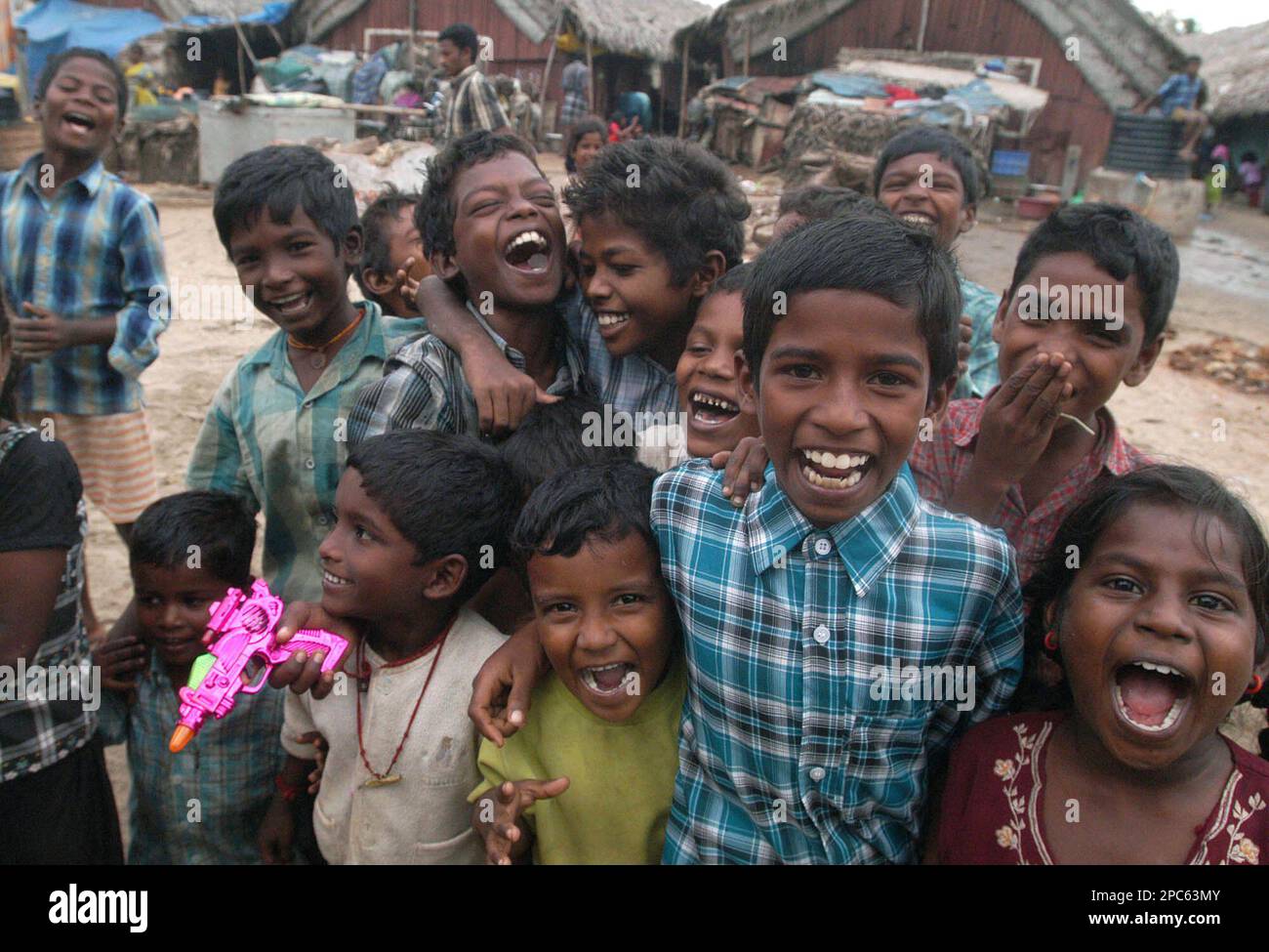 Children, survivors of the Dec.26, 2004 tsunami laugh for the camera at  Keechankuppam temporary camp in Nagapattinam, around 320 kilometers (200  miles) south of Chennai, India, Monday, Dec. 25, 2006. Nagapattinam is