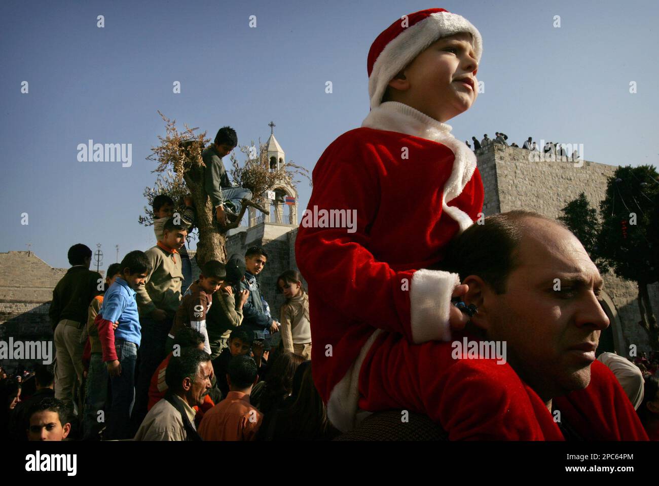 Palestinians watch the traditional Christmas procession of the Latin ...