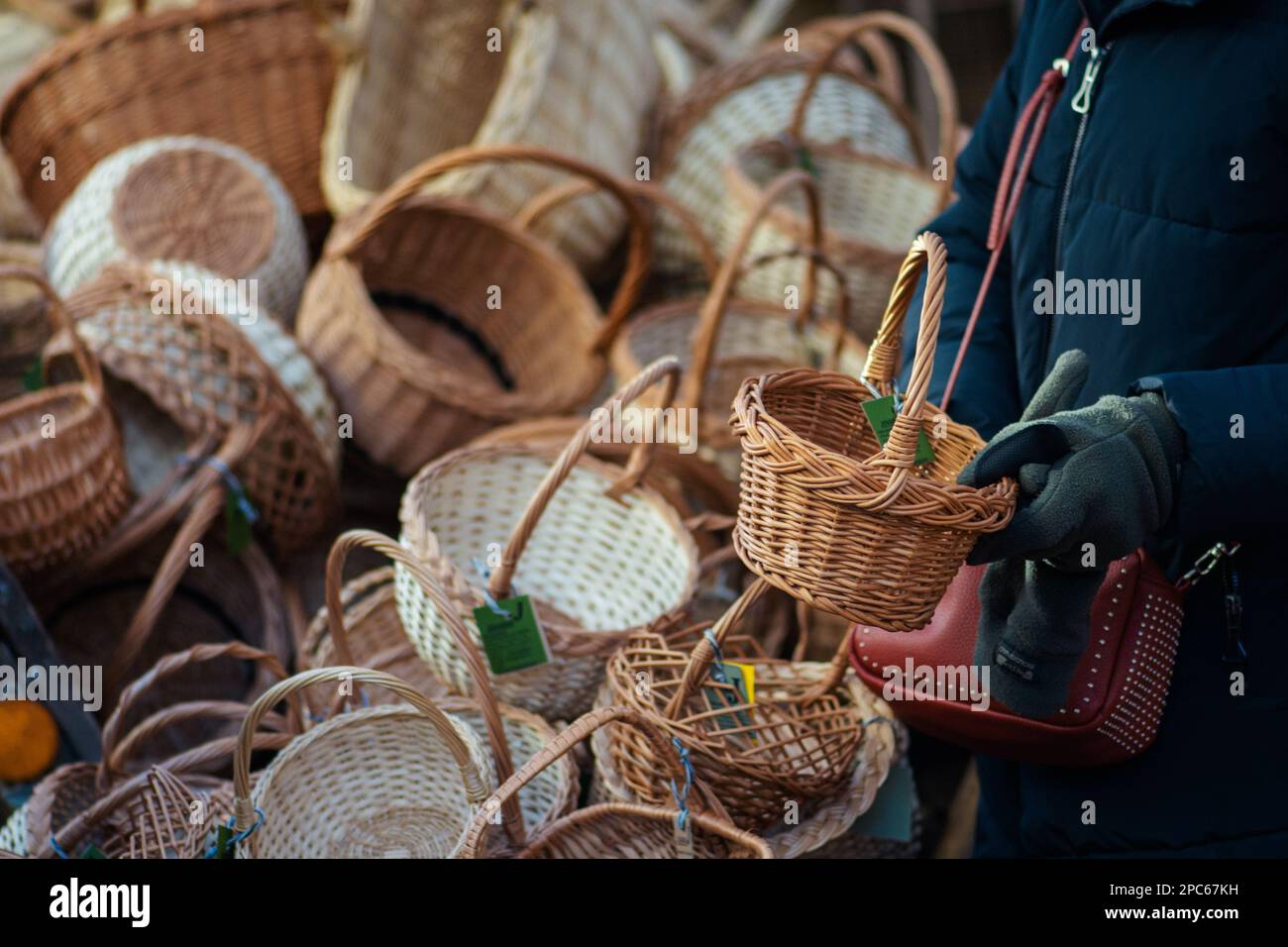 Group of hanging empty wicker baskets for sale in a street market or