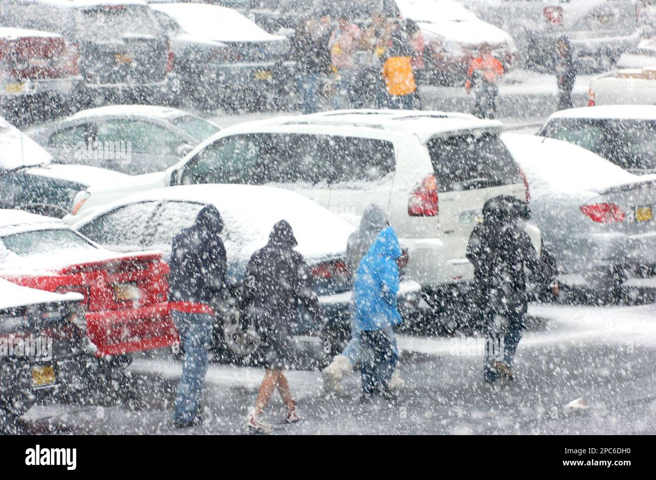Moviegoers hustle through snow to a matinee at Cottonwood Mall in