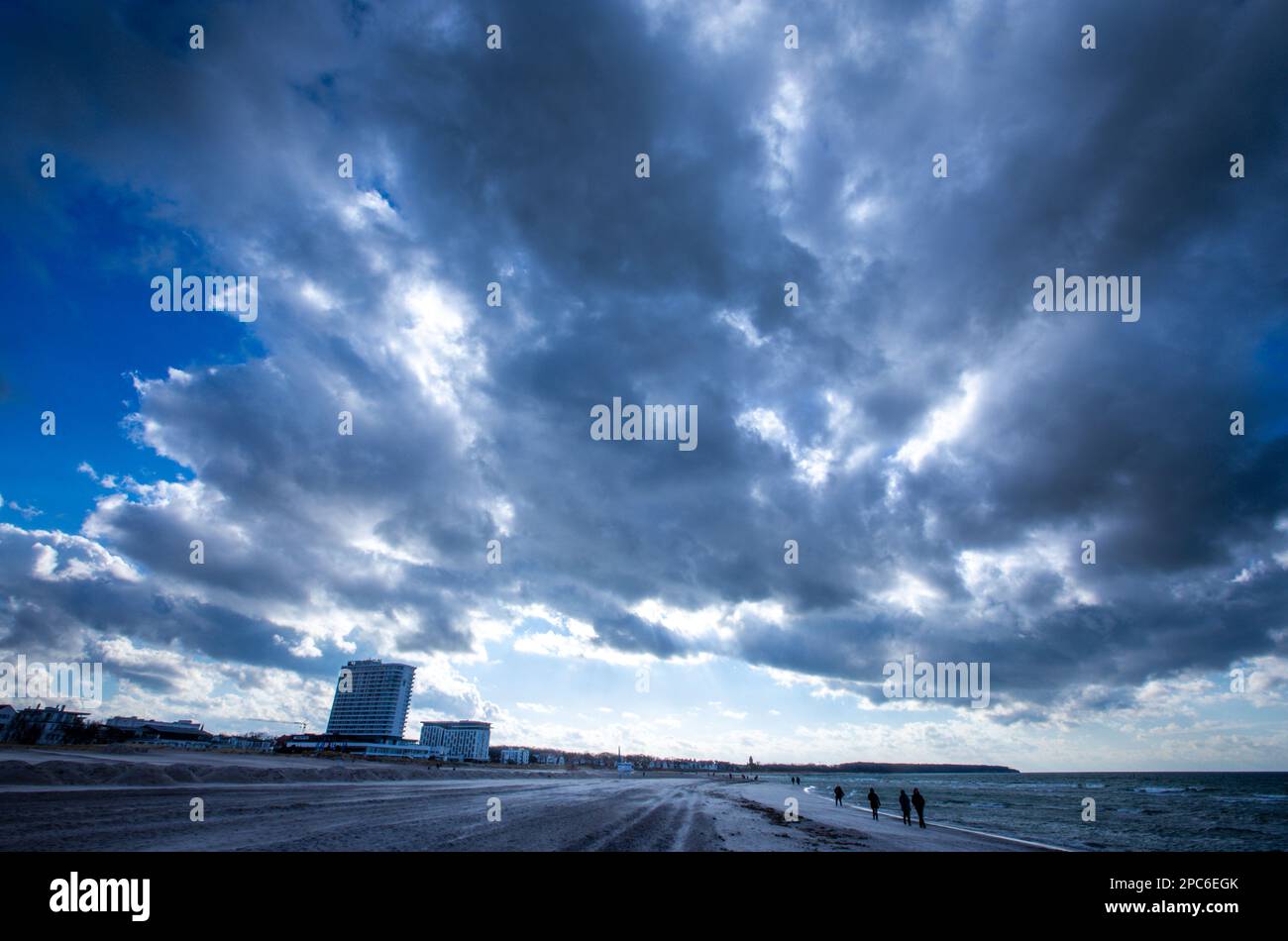 Rostock, Germany. 13th Mar, 2023. Dark clouds move over the beach in