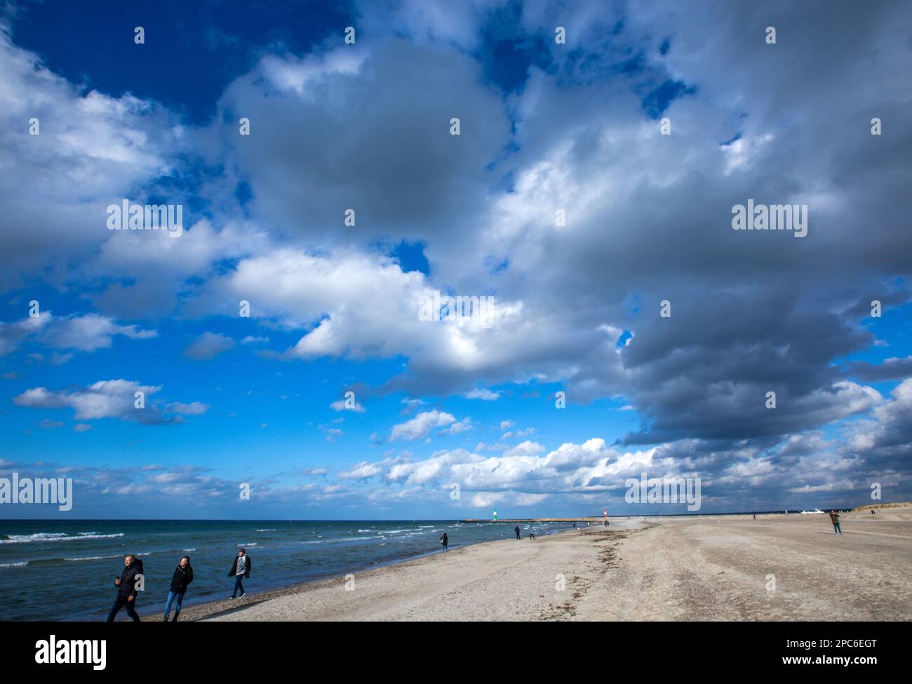 Rostock, Germany. 13th Mar, 2023. Walkers are on the beach in