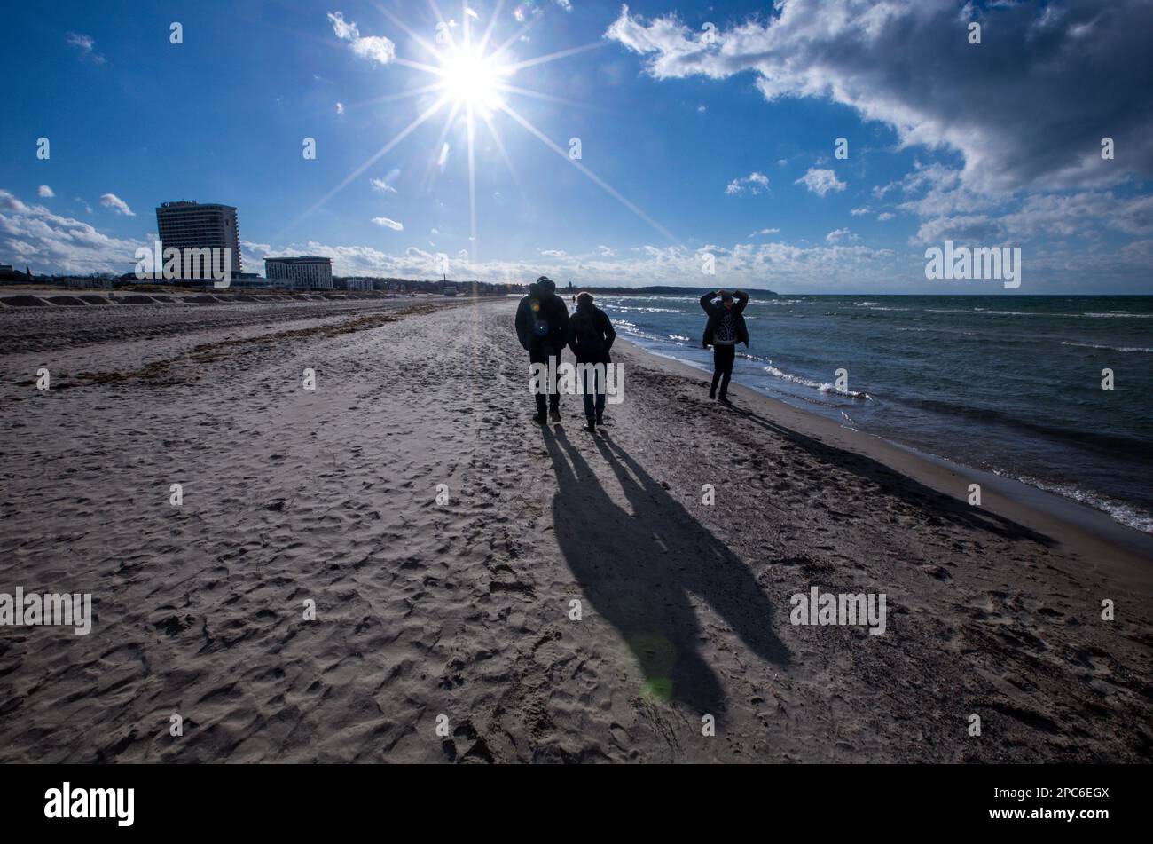 Rostock, Germany. 13th Mar, 2023. Walkers are on the beach in