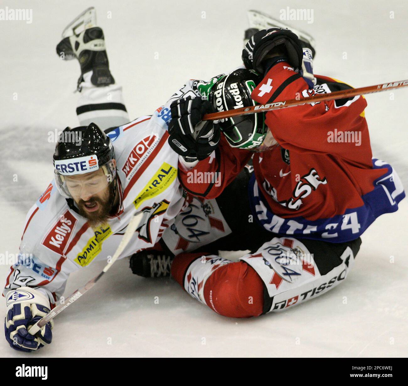 Markus Peintner, left, from Austria collides with Beat Forster, right, of Switzerland during their Loto Cup Ice Hockey match played in Bratislava, Slovakia, Saturday Dec. 16, 2006. Switzerland defeated Austria 3-1and gained itself the Loto Cup 2006 title. (AP Photo/Petr David Josek) Stock Photo