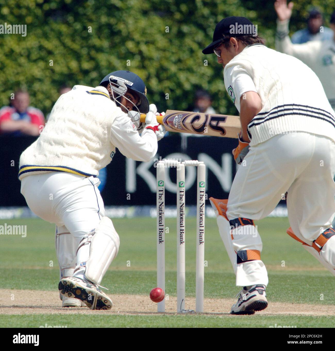Sri Lanka's Chamara Silva, left, looks back at his stumps in front of
