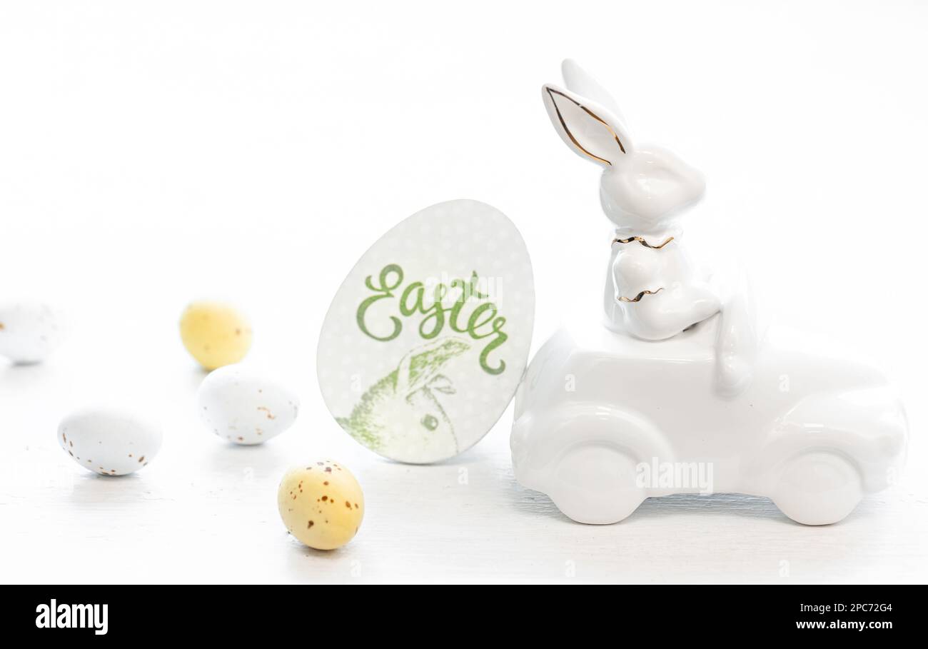 Easter background with a ceramic hare in the car and eggs on a ...