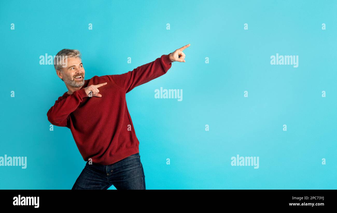 Cool middle aged man pointing at copy space, panorama Stock Photo