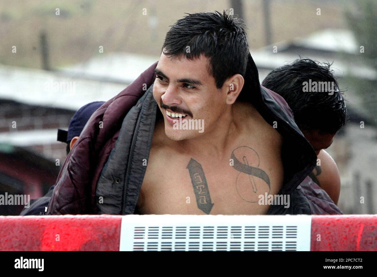 A Gang Member Of The Mara 18 Smiles As He Is Captured By The Police   A Gang Member Of The Mara 18 Smiles As He Is Captured By The Police During A Sudden Incursion At Colony Habitat In Tegucigalpa Honduras Tuesday Dec 12 2006 Honduras Has Registered Some 40000 Gang Members Ap Photoedgard Garrido 2PC7CT2 