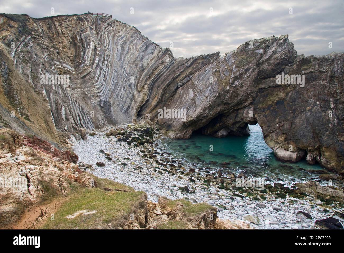 Geological rock formations with rock folding and archways cut into softer rocks of the bay, Stair Hole, Dorset, England, Marsh Stock Photo