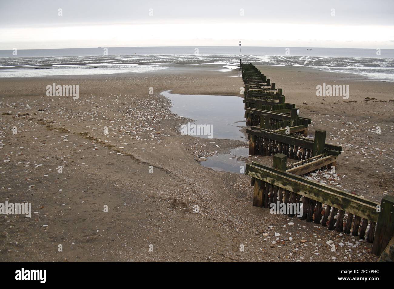 View of beach and groyne at low tide, The Wash, Hunstanton, Norfolk, England, United Kingdom Stock Photo