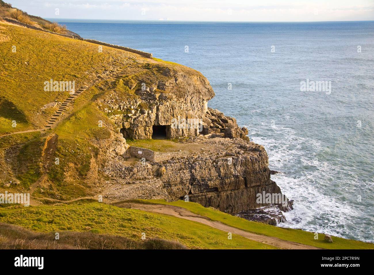 View of coastline with artificial caves in cliff, former Purbeck Stone limestone quarry, Tilly Whim Caves, Durlston, Isle of Purbeck, Dorset Stock Photo