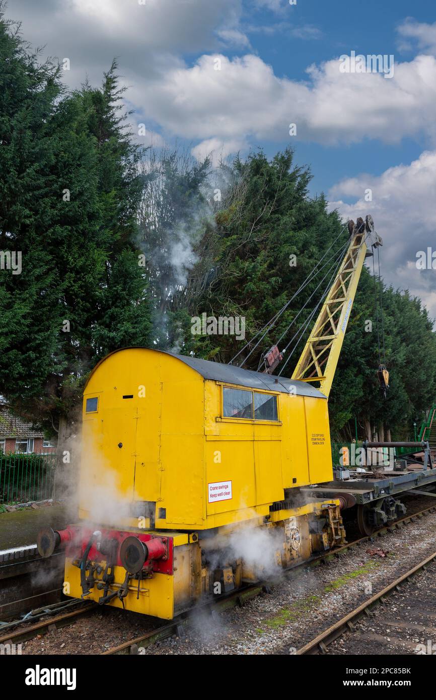 Working Steam Powered Railway Crane. DS58 10 Ton Lift on the Watercress Line in Hampshire. Smoke billowing from funnel. Stock Photo