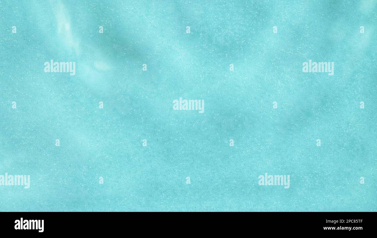 Blurred transparent blue colored clear calm water surface texture with ...