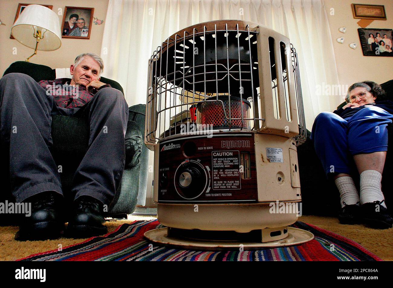 Bill Breazeale and his wife, Louise, stay warm by sitting next to a