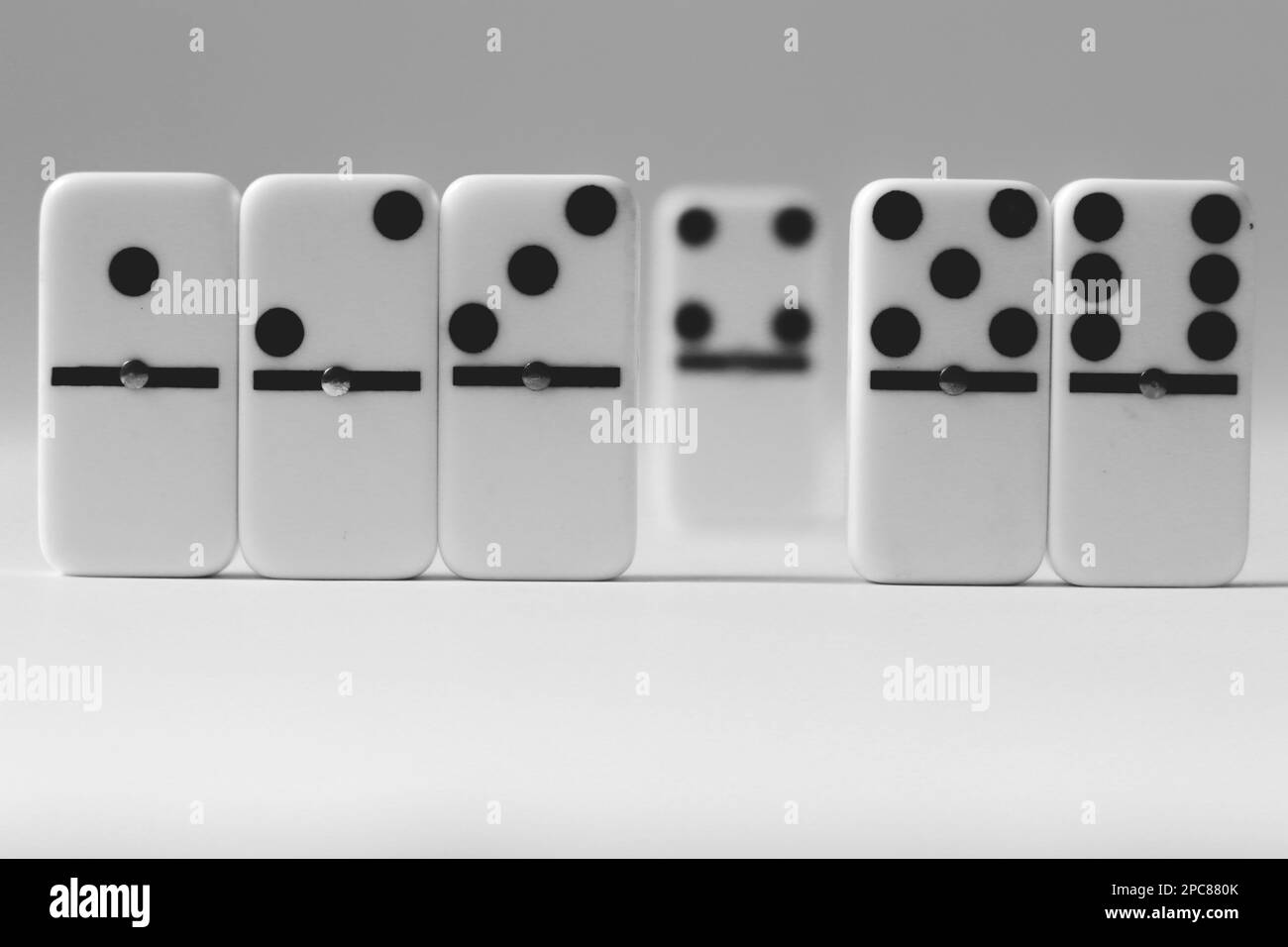 Domino effect for business ideas, one peice of dominos in white background with negative space, strategy and successful interventions, board game, ind Stock Photo