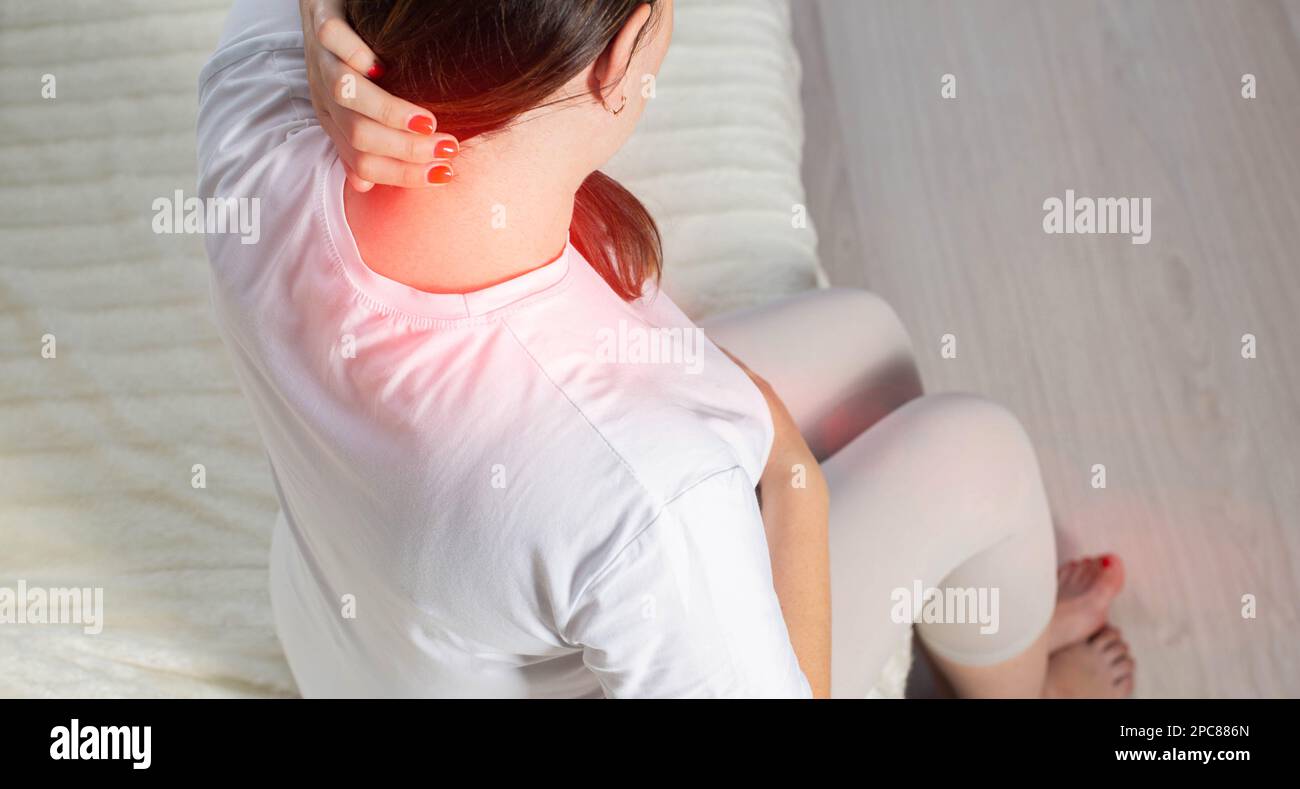 Redness and pain in the neck of a pregnant girl. Overstrain of the neck muscles, myofascial syndrome. Stock Photo