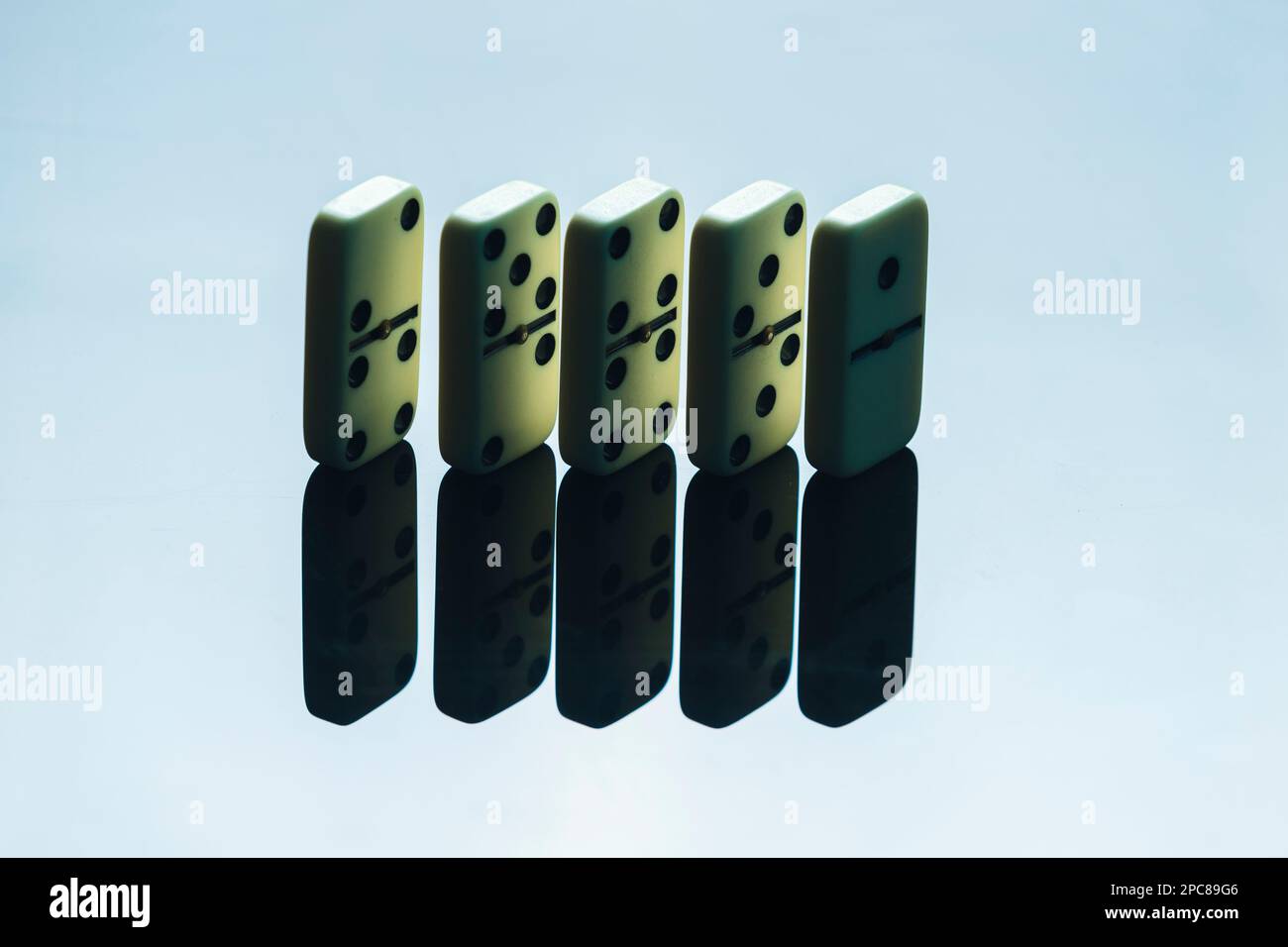 Domino effect for business ideas, two pieces of dominos in grey