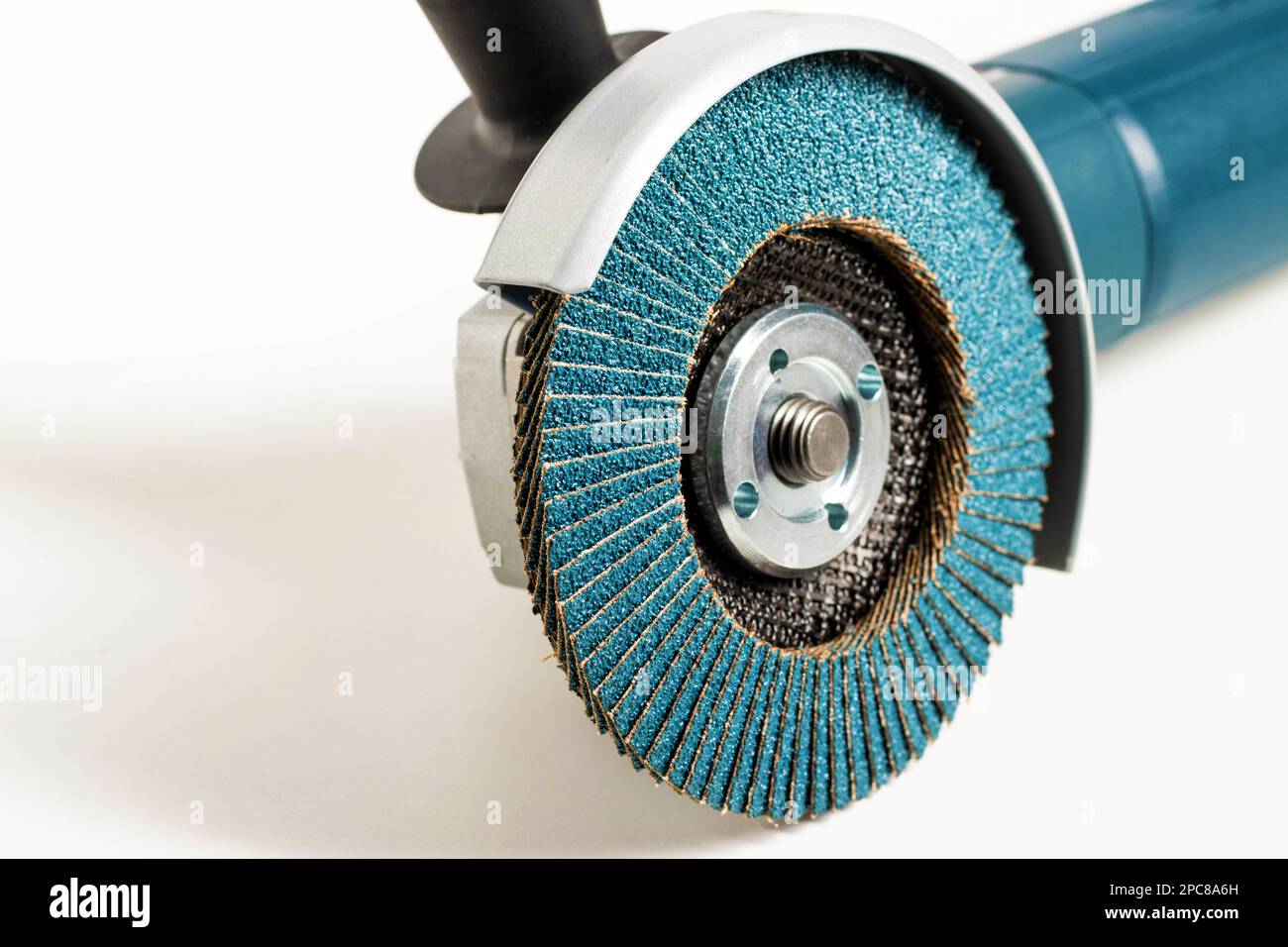 Modern professional angle grinder with a flap wheel on a white