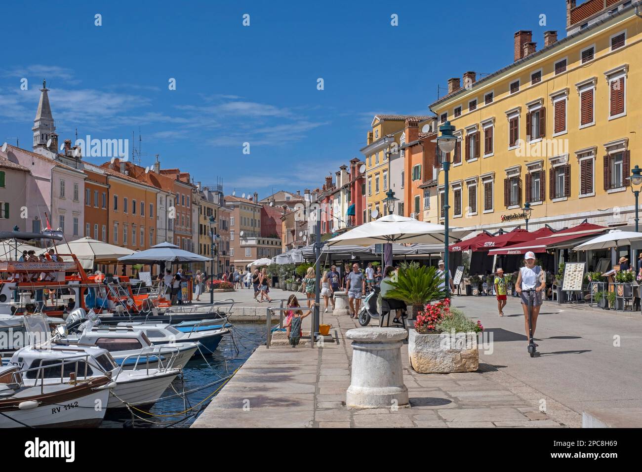 Tourists wandering in the harbour of the city Rovinj / Rovigno, seaside resort along the north Adriatic Sea, Istria County, Croatia Stock Photo