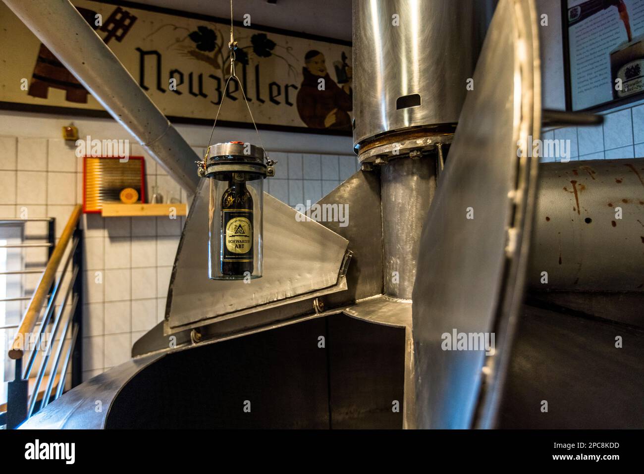 The bottle of Black Abbot blessed by Pope Francis is dipped into the brew kettle during each brewing process. Brewery Klosterbrauerei Neuzelle, Germany Stock Photo