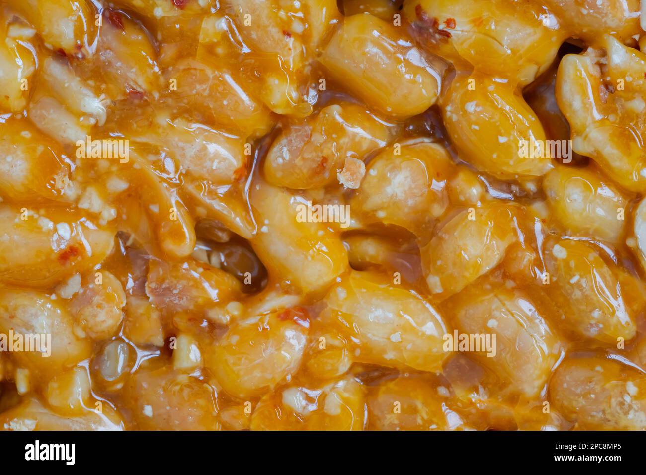 Caramelized nuts fried in honey granola peanut bar close up, top