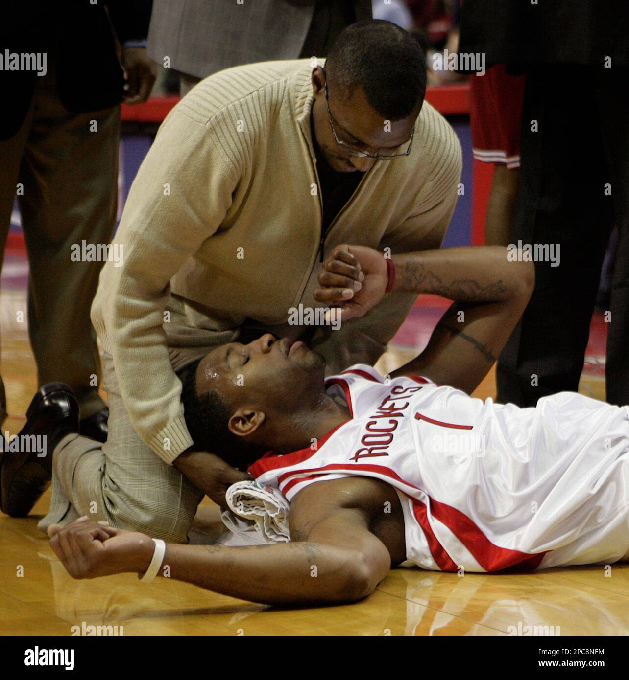 Houston Rockets forward Tracy McGrady (11) is tended to by