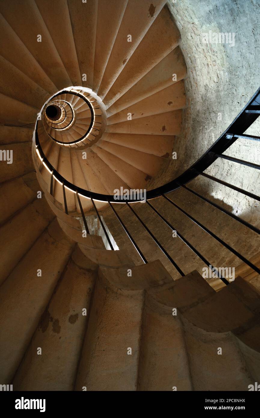 Ancient castle tower interior with spiral staircase leading up Stock Photo