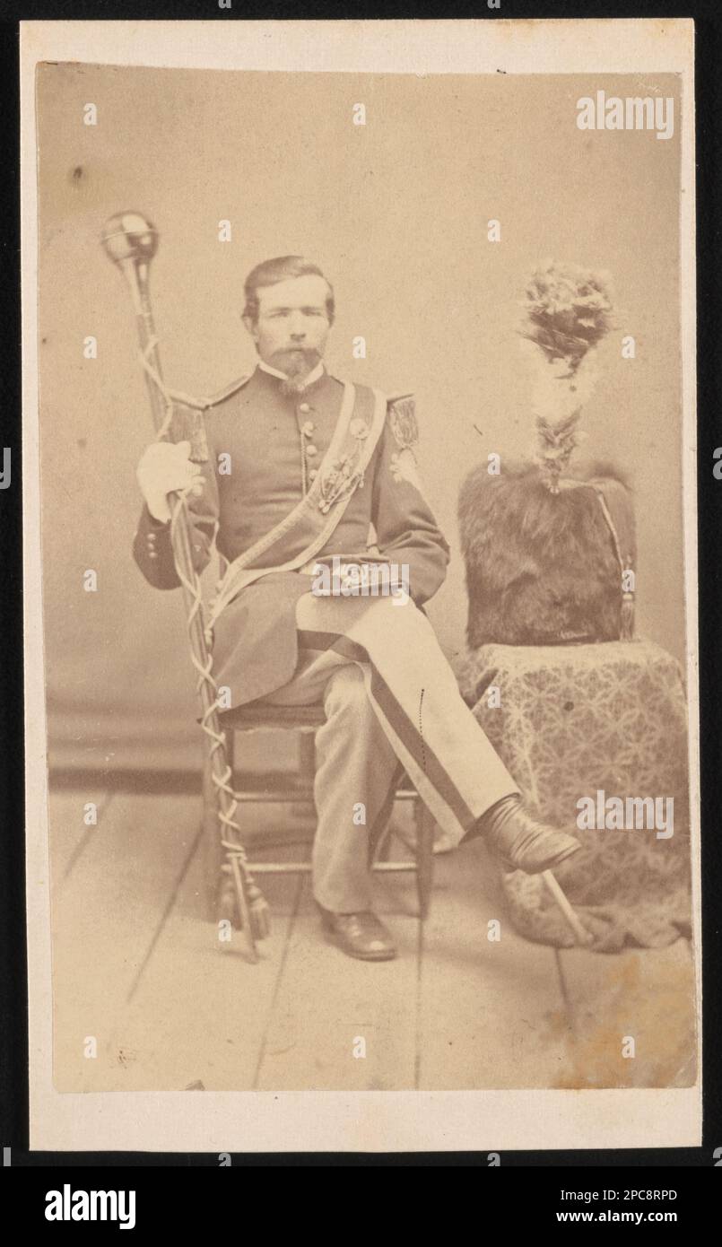 Unidentified band master of 6th Infantry in Union uniform with drum major mace (baton), 6th Infantry insignia on hat and bearskin shako hat on stand. Liljenquist Family Collection of Civil War Photographs , pp/liljpaper. United States, Army, Infantry Regiment, 6th, People, 1860-1870, Soldiers, Union, 1860-1870, Military uniforms, Union, 1860-1870, Musicians, 1860-1870, Ceremonial maces, 1860-1870, Drum majors, 1860-1870, Conductors, 1860-1870, United States, History, Civil War, 1861-1865, Military personnel, Union. Stock Photo