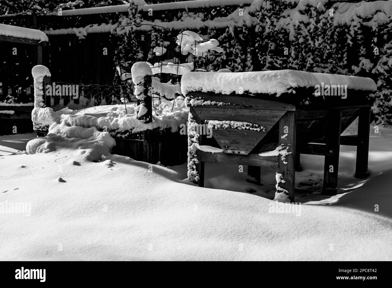 Black and white photo of a planter boxes covered with snow Stock Photo