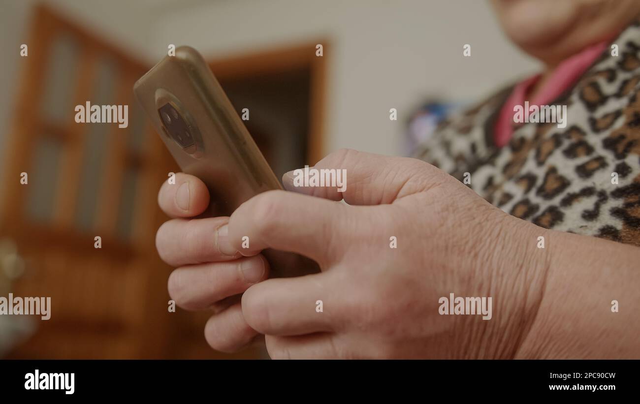 Tech-Savvy Elderly Woman: Using Smartphone with Ease Stock Photo