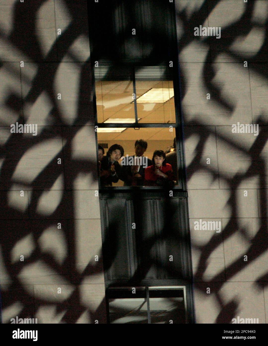 Window Flasher Spectators Spectators in an office window look down on the crowd as a snowflake ...