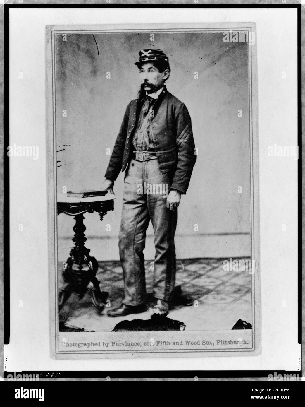 Robert H. Kelly, Union soldier, full-length portrait, standing, facing left. Printed on mount: Photographed by Purviance, cor. Fifth and Wood Sts, Pittsburgh, Handwritten on verso: Bugler Kelly - Knap's Pa Batty, In album: [U.S. army officers and other persons of the Civil War period / John White Geary, comp. 1861-1865], no. 46, surrogate p. 12 (upper right), Identified by Amy Jones (May 2011). See the muster roll for 'Knap's Battery, Pennsylvania Volunteers, Independent Battery E', (www.pa-roots.com/pacw/artillery/indbatte.html), Surrogate available as color laser copy in P&P Reading Room. So Stock Photo