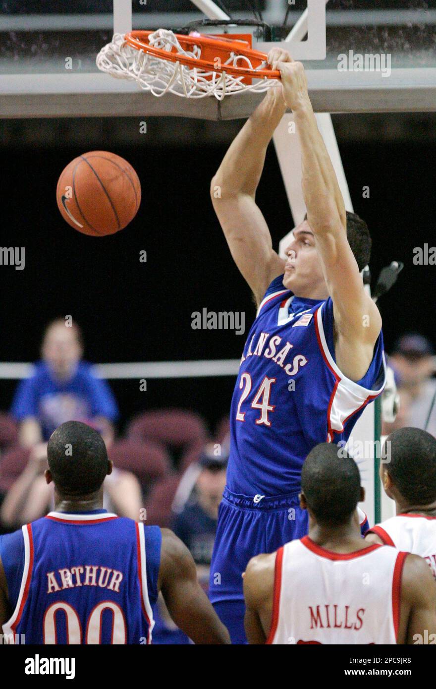 Kansas' Sasha Kaun dunks as teammate Darrell Arthur and Ball State's