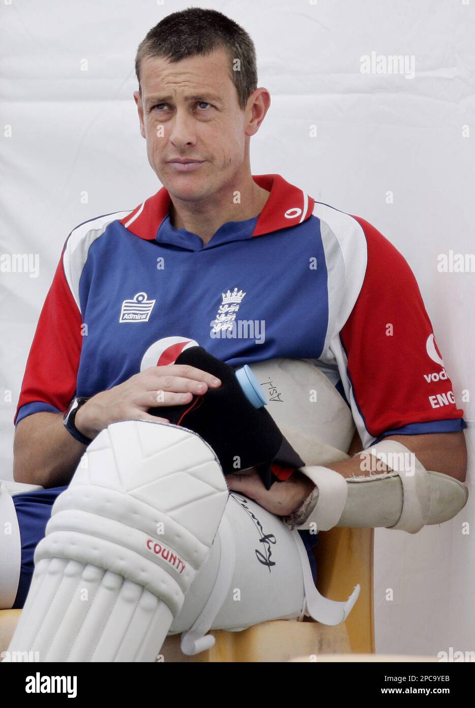 England spin bowler Ashley Giles holds a ice pack on his hand after injuring his fingers during a net session on the eve of the first cricket test against Australia at the