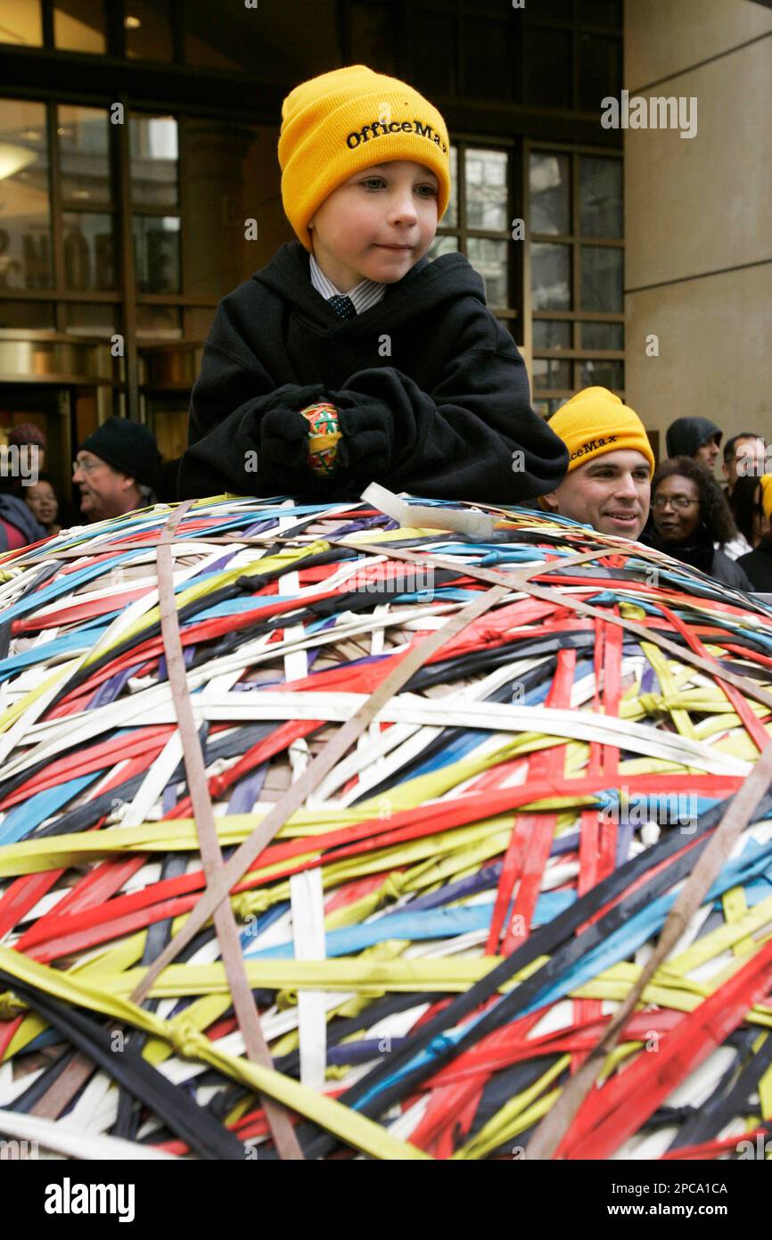 Brice Milton of Eugene, Ore., lays on top of the world's largest rubber band ball with his