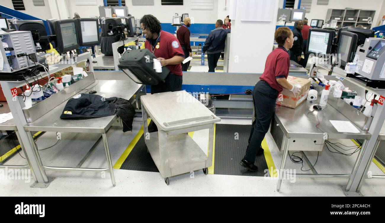 Suitcases are readied for inspection by Transportation Security ...