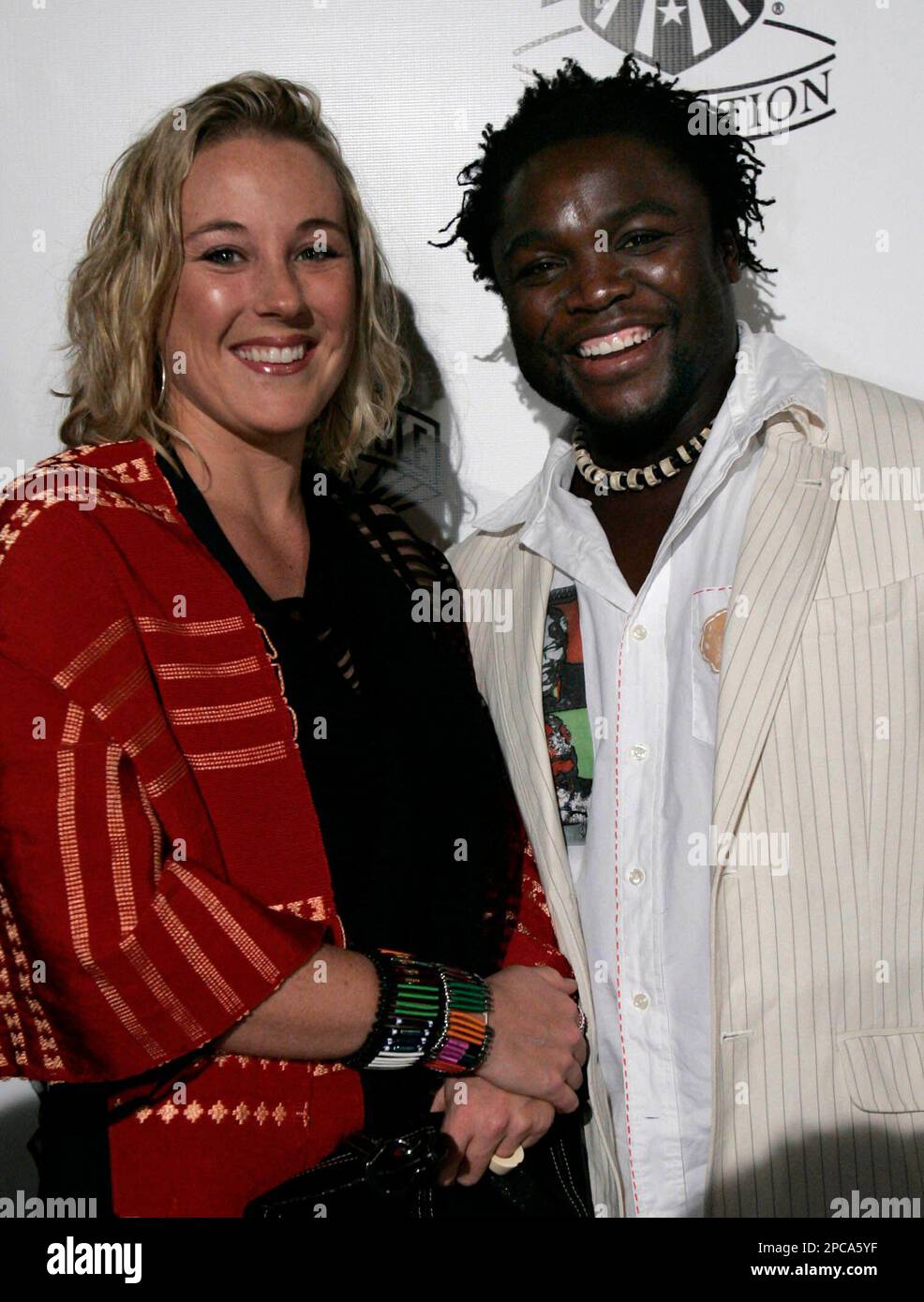 Sunu Gonera, director of the movie "Pride," poses for photographs with his wife Rene during the arrivals to the Golden Goggle Awards held at the Beverly Hilton in Beverly Hills, Calif., on Sunday, Nov. 19, 2006. (AP Photo/Ann Johansson) Stock Photo