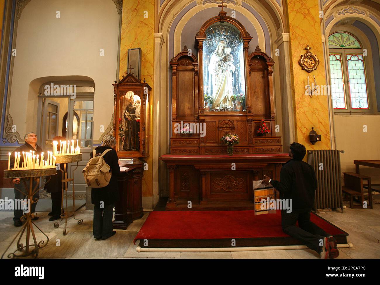 A Christian man prays at the St. Esprit Cathedral, the cathedral of the