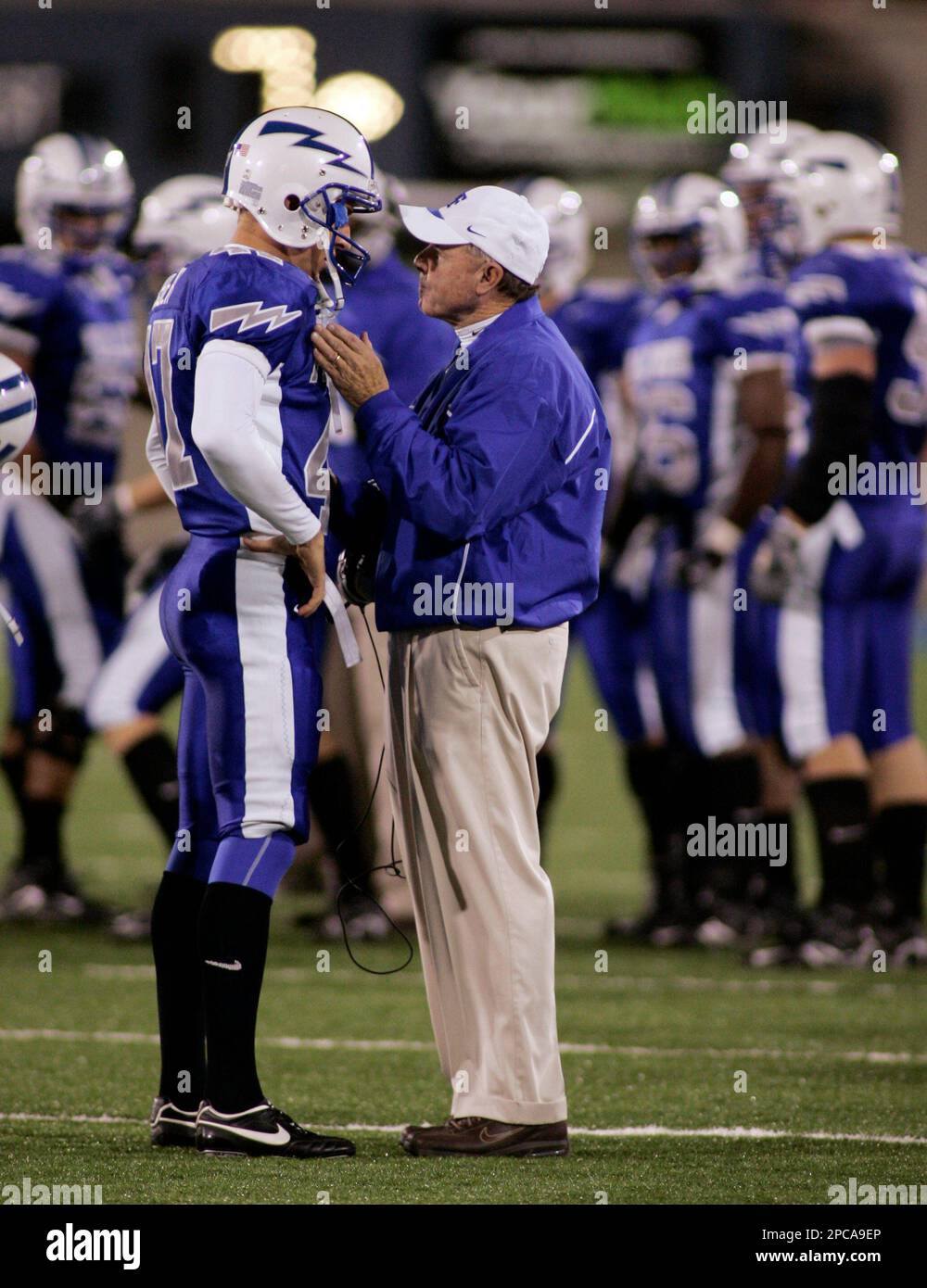 Air Force coach Fisher DeBerry talks with kicker Zach Sasser after