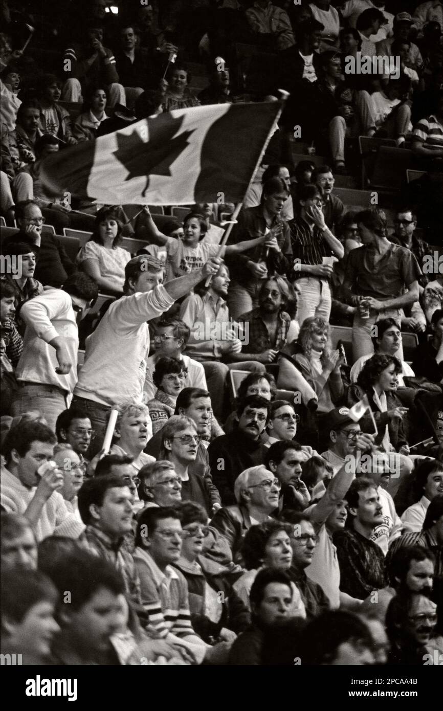 A hockey fan waving the Canadian flag at a international hockey tournament at the Calgary Saddledome arena, December 30, 1986 Stock Photo