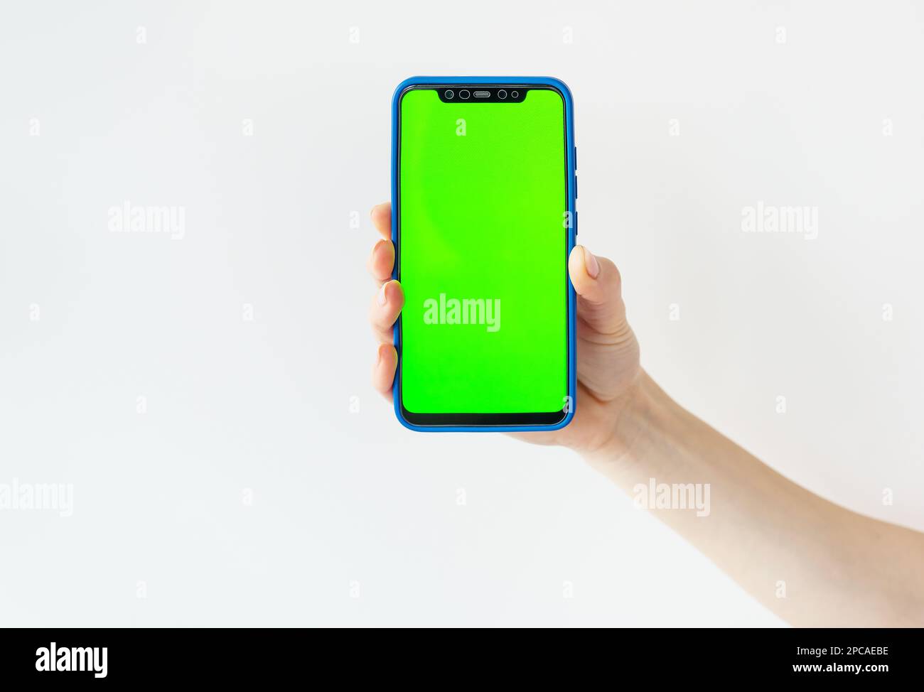 Mockup image, girl holding smartphone with blank green screen on white ...